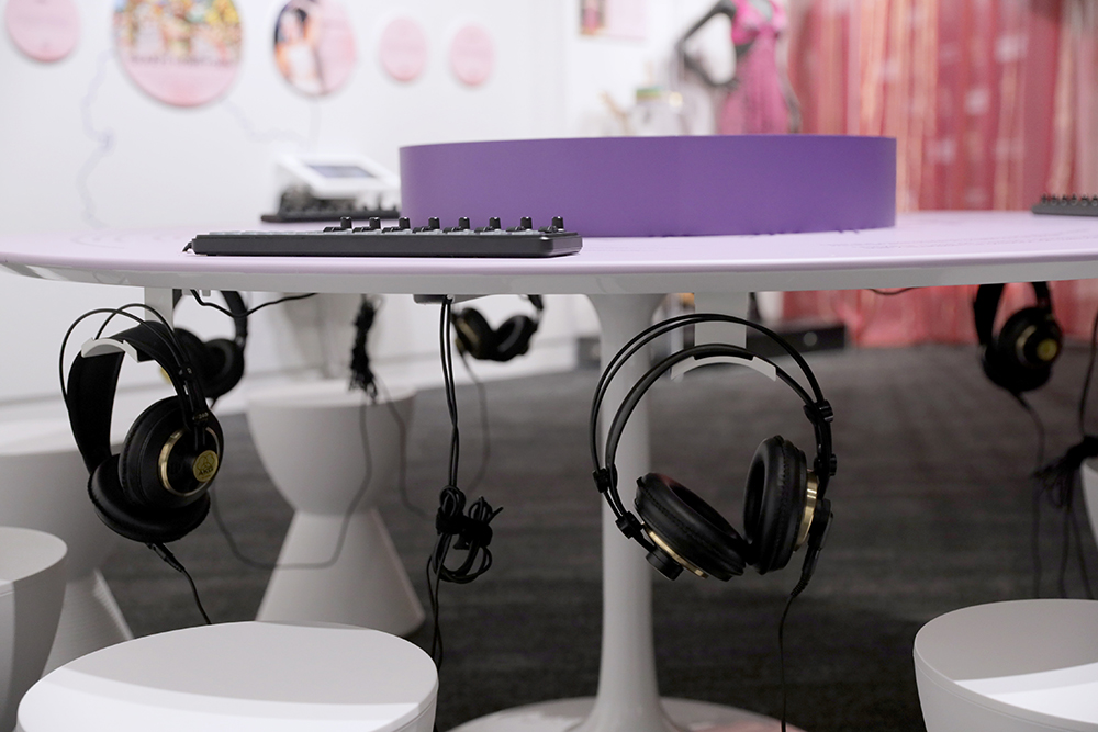 GRAMMY Museum interactive exhibit featuring headphones hanging under a table